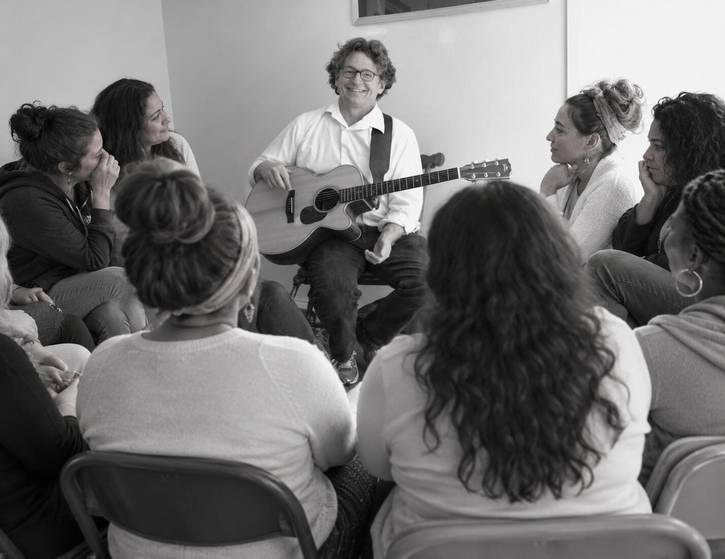 Macheis Wind in a healing circle, with several women looking emotional and happy.